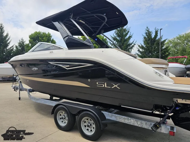 Slide: The Image of 2016 Sea Ray 250 SLX boat on trailer, sleek design, black and white exterior. - 22