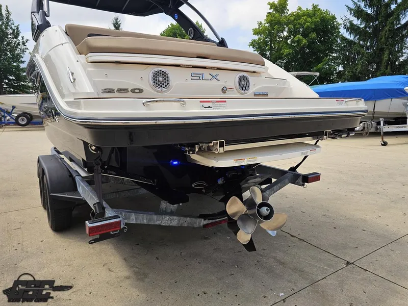 Slide: The Image of 2016 Sea Ray 250 SLX boat on trailer, rear view with propeller visible. - 24