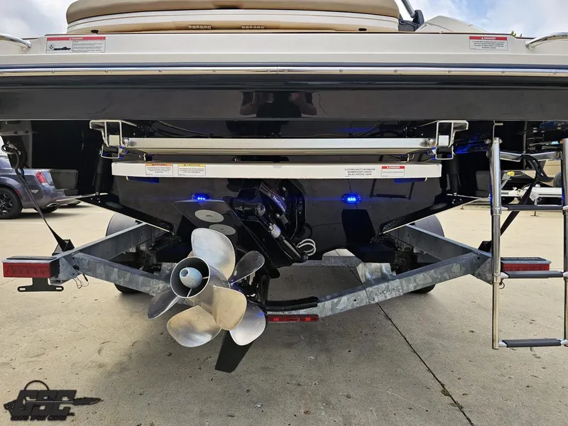 Slide: The Image of Rear view of a 2016 Sea Ray 250 SLX boat on a trailer, showcasing the propeller and ladder. - 26