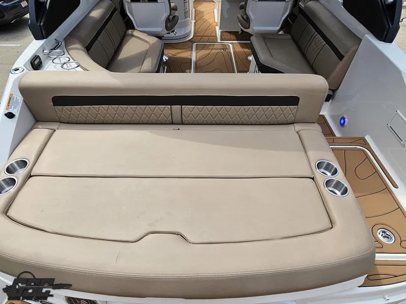 Slide: The Image of 2016 Sea Ray 250 SLX boat interior with beige seating and cup holders. - 31