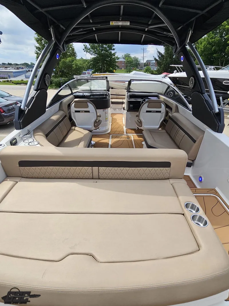 Slide: The Image of 2016 Sea Ray 250 SLX boat interior with beige seating and modern design. - 32