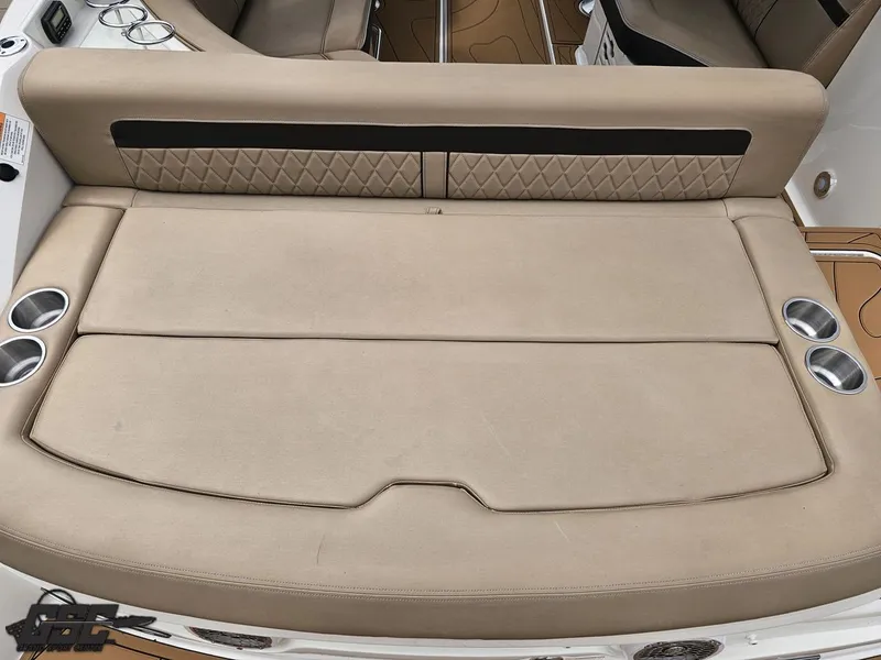 Slide: The Image of 2016 Sea Ray 250 SLX boat with beige cushioned seating and cup holders. - 33