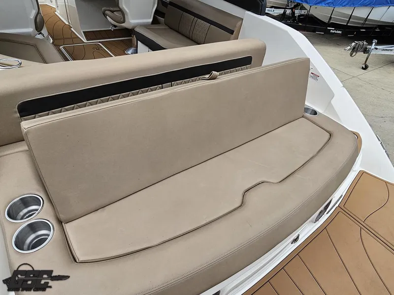 Slide: The Image of 2016 Sea Ray 250 SLX boat interior with beige seating and cup holders. - 34