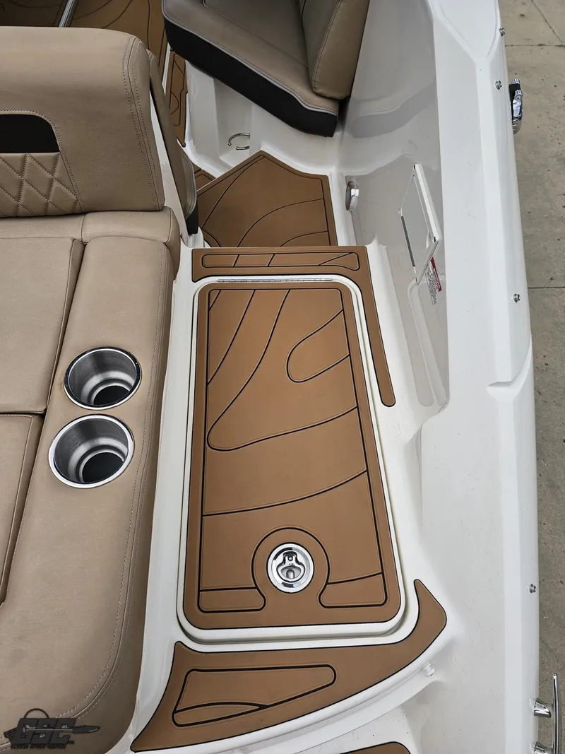 Slide: The Image of 2016 Sea Ray 250 SLX boat interior with tan seating and cup holders. - 35