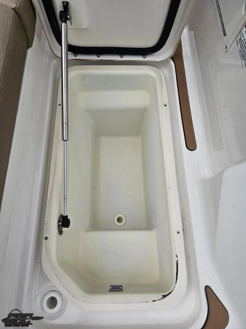 Slide: The Image of Open storage compartment on a 2016 Sea Ray 250 SLX boat, featuring a hydraulic lift. - 36