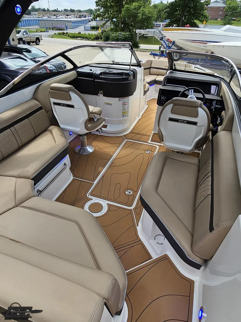 Slide: The Image of 2016 Sea Ray 250 SLX boat interior with tan seating and modern dashboard. - 38
