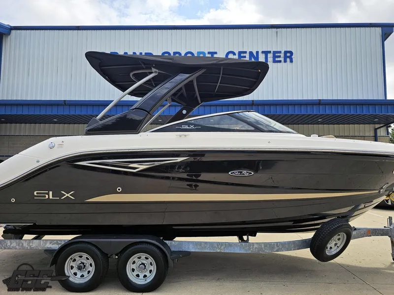 Slide: The Image of 2016 Sea Ray 250 SLX boat on trailer outside a marine sport center. - 4