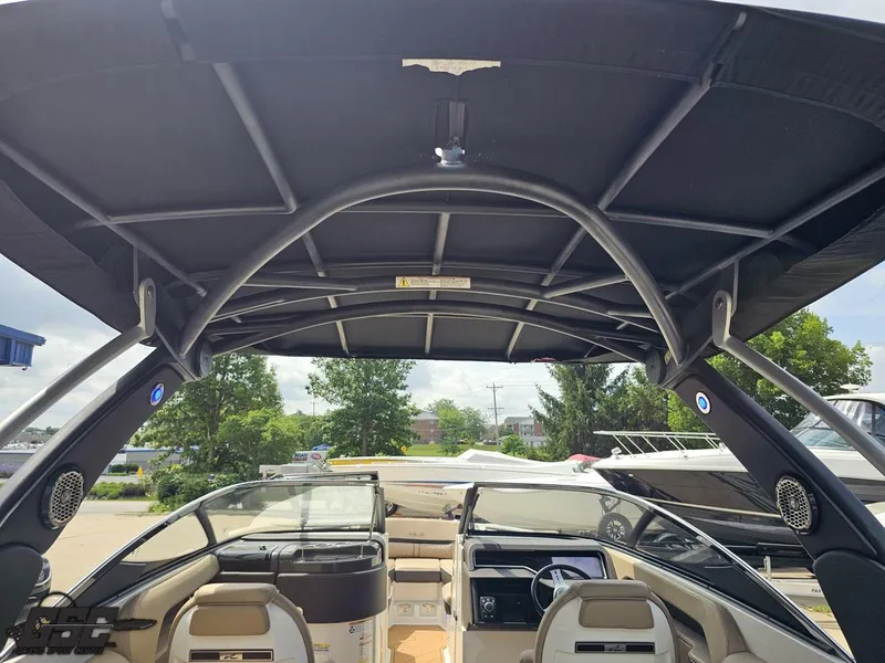 Slide: The Image of 2016 Sea Ray 250 SLX boat interior with canopy, featuring seating and dashboard. - 41