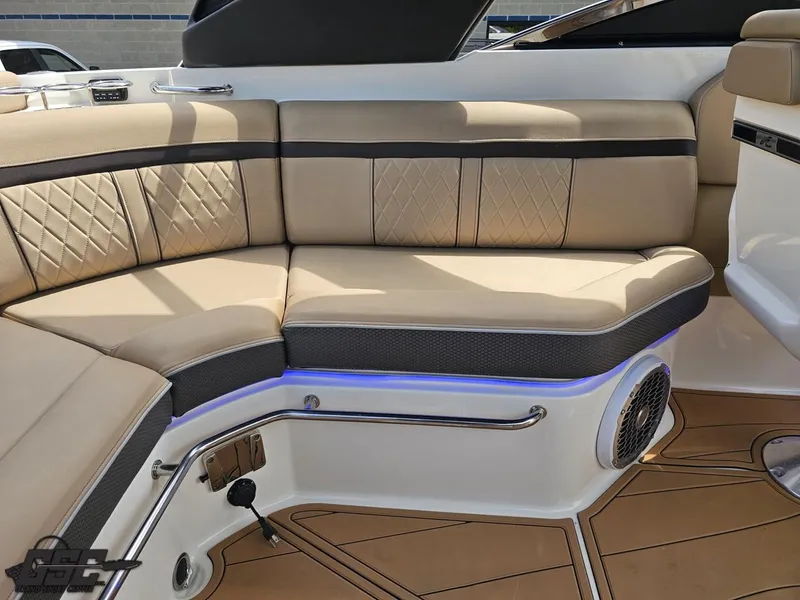 Slide: The Image of Luxurious seating on 2016 Sea Ray 250 SLX boat with beige upholstery and blue LED lighting. - 43