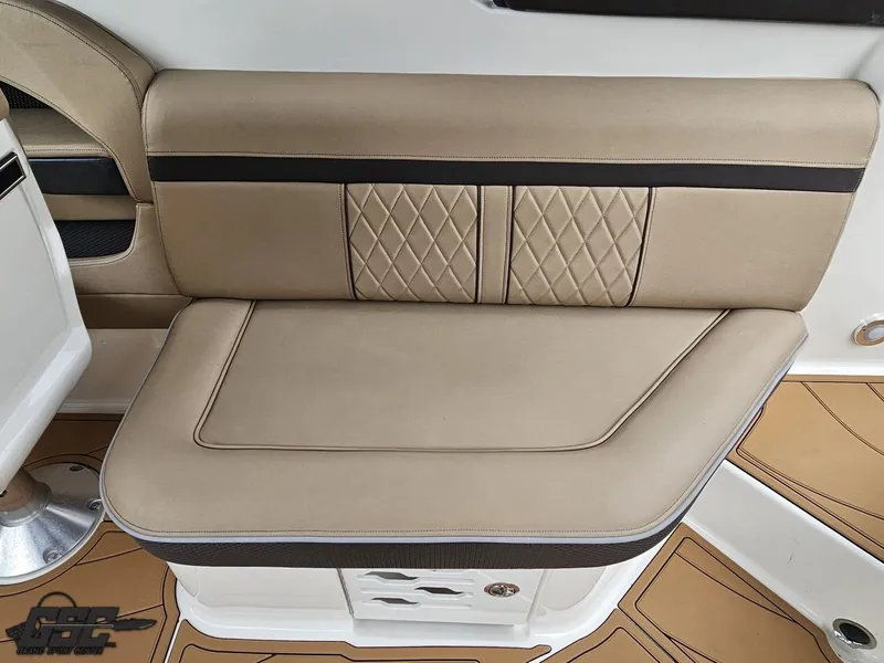 Slide: The Image of 2016 Sea Ray 250 SLX boat interior with beige cushioned seating and diamond stitching. - 46