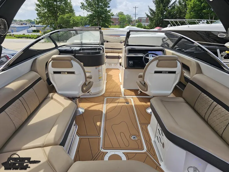 Slide: The Image of 2016 Sea Ray 250 SLX boat interior with tan seating and modern dashboard. - 48