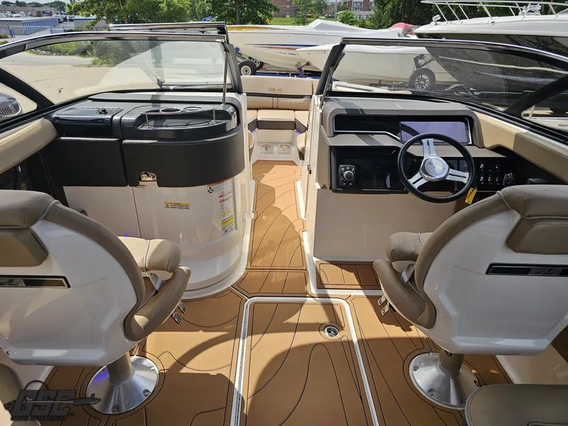 Slide: The Image of 2016 Sea Ray 250 SLX boat interior with tan seating and modern dashboard. - 49