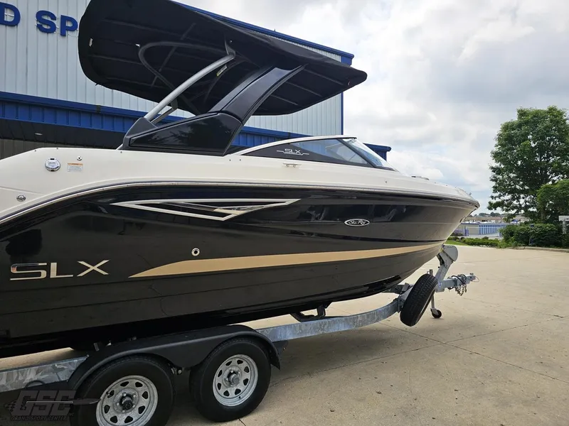 Slide: The Image of 2016 Sea Ray 250 SLX boat on trailer, parked outdoors near a building. - 8