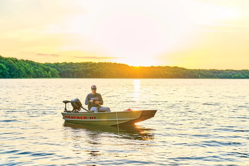 Slide: The Image of Manufacturer Provided Image: Man fishing on a 2026 Tracker Grizzly 10 Jon boat at sunset. - 13