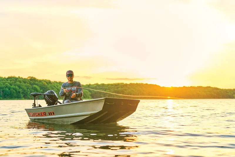 Slide: The Image of Manufacturer Provided Image: Person fishing on a 2026 Tracker Grizzly 10 Jon boat at sunset. - 14