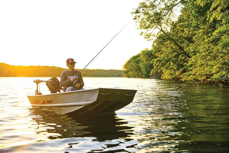 Slide: The Image of Manufacturer Provided Image: Man fishing on a 2026 Tracker Grizzly 10 Jon boat at sunset. - 16