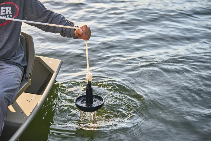 Slide: The Image of Manufacturer Provided Image: Person using anchor on Tracker Grizzly 10 Jon boat, 2026 model, in water. - 18