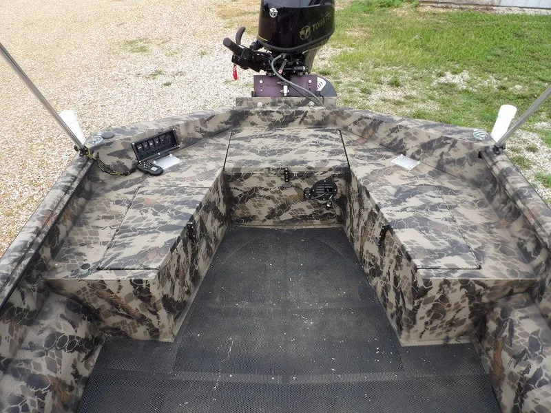 Slide: The Image of Camouflage-patterned interior of a 2021 Havoc VJST-C 1756 boat with motor and control panel. - 13