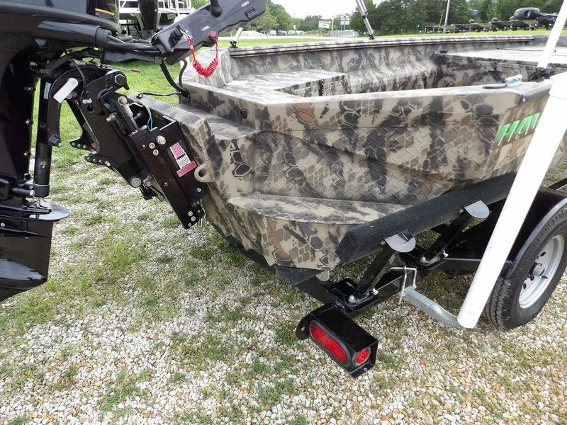 Slide: The Image of Camouflage-patterned Havoc VJST-C 1756 boat, 2021 model, on a trailer with motor attached. - 32