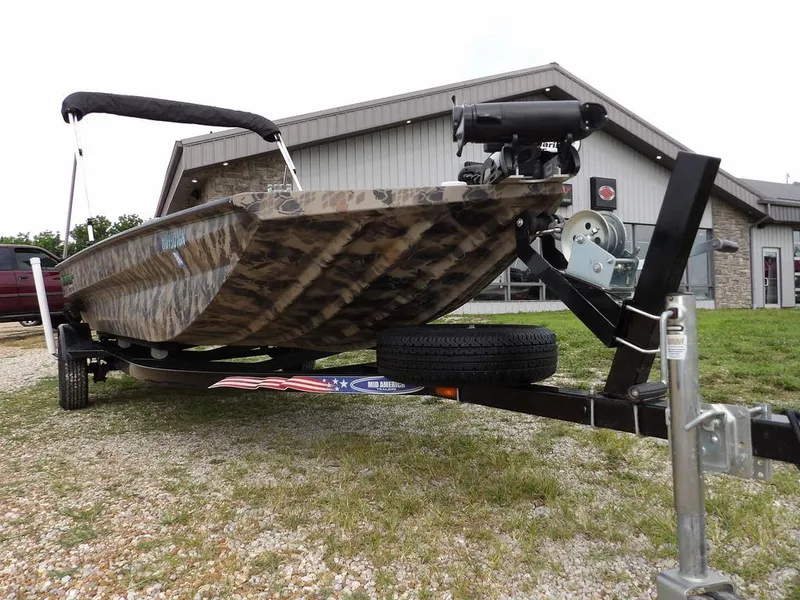 Slide: The Image of 2021 Havoc VJST-C 1756 boat on trailer, camo design, parked outside a building. - 35