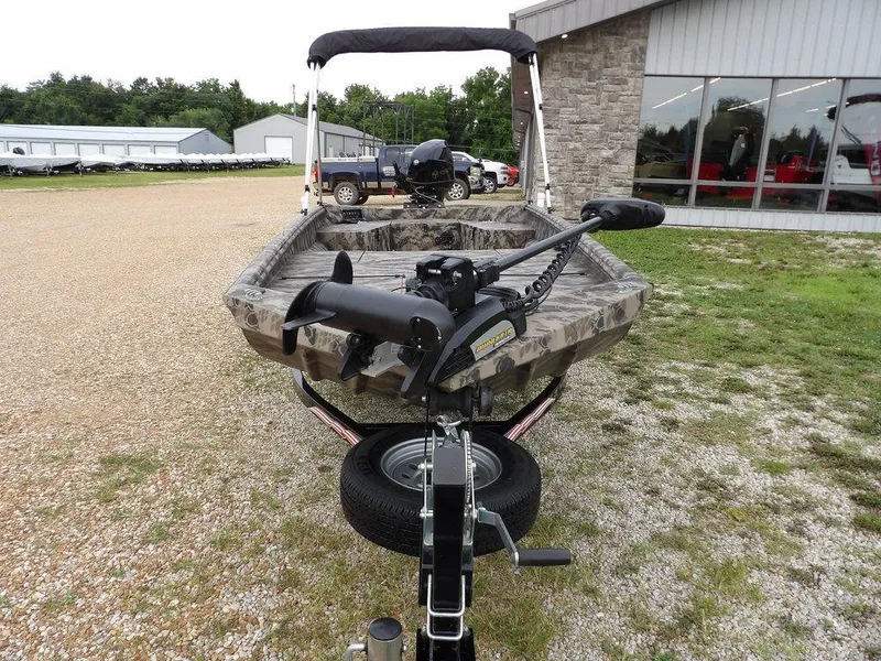 Slide: The Image of 2021 Havoc VJST-C 1756 boat with camouflage design, parked outdoors near a building. - 4