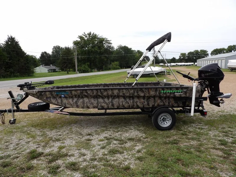 Slide: The Image of 2021 Havoc VJST-C 1756 boat with camouflage design on a trailer, parked outdoors. - 6