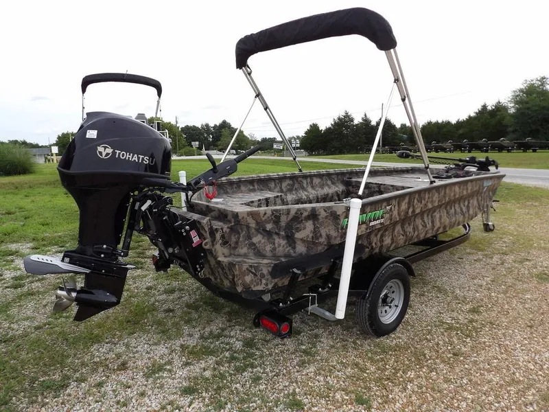 Slide: The Image of 2021 Havoc VJST-C 1756 boat with Tohatsu motor, camo design, on trailer, parked outdoors. - 8