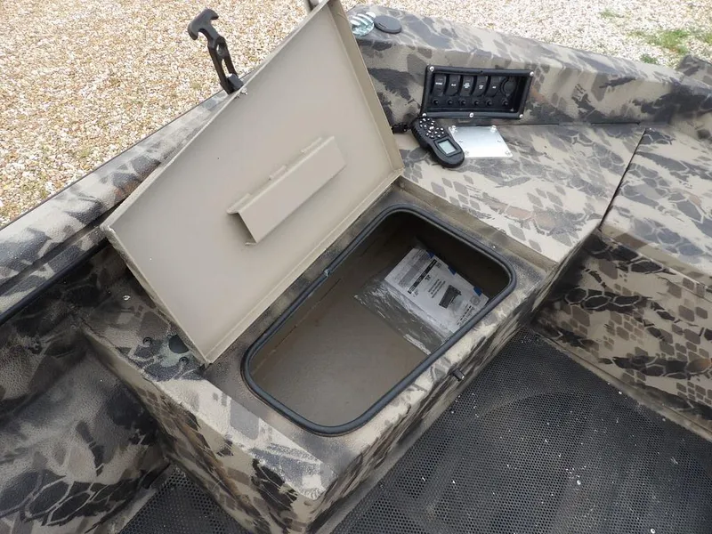 Slide: The Image of Open storage compartment in 2021 Havoc VJST-C 1756 boat with camouflage design and control panel. - 9