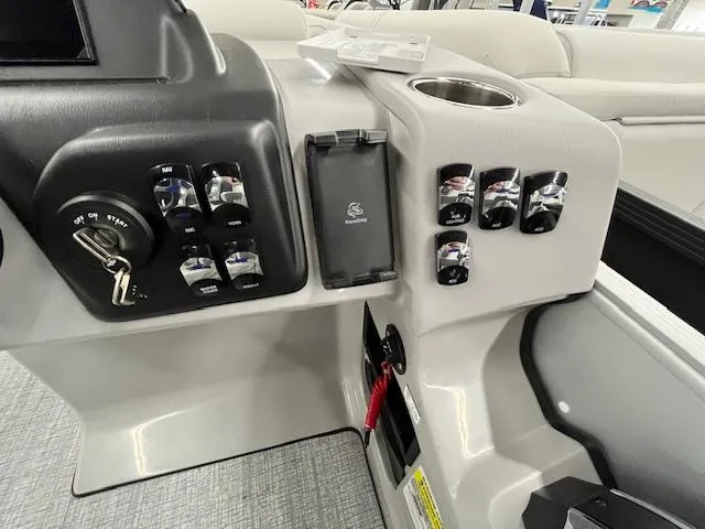 Slide: The Image of Control panel of 2025 Harris Cruiser 210 boat with switches and key ignition. - 15