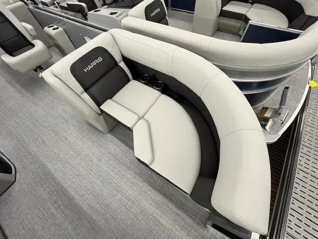 Slide: The Image of 2025 Harris Cruiser 210 boat interior with plush seating and cup holders. - 2