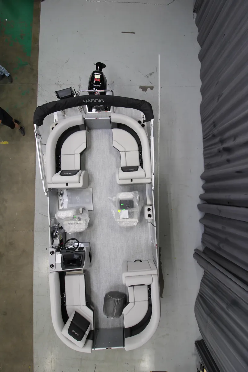 Slide: The Image of 2025 Harris Cruiser 210 pontoon boat, top view, showcasing spacious seating and modern design. - 5