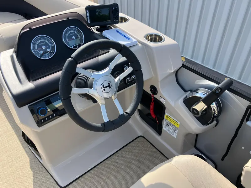 Slide: The Image of 2025 Harris Cruiser 230 dashboard with steering wheel and control panel. - 13