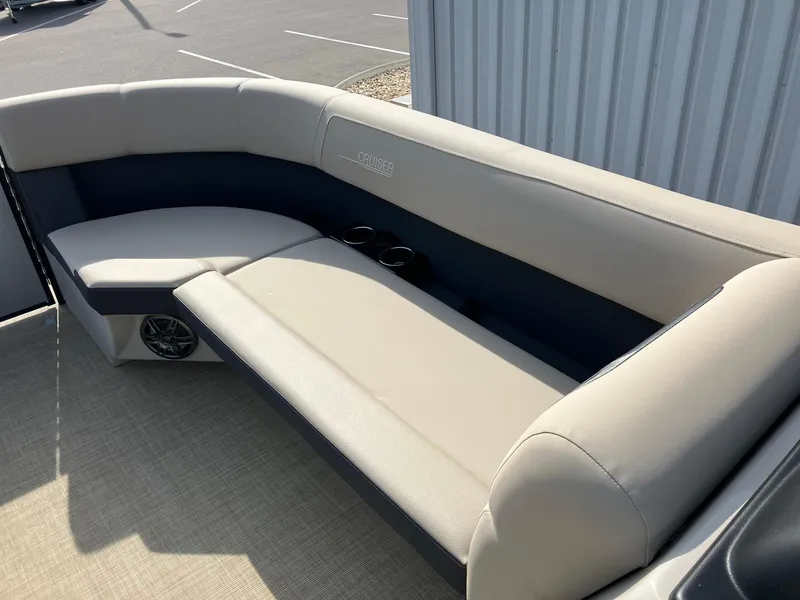 Slide: The Image of 2025 Harris Cruiser 230 boat interior with beige seating and cup holders. - 15