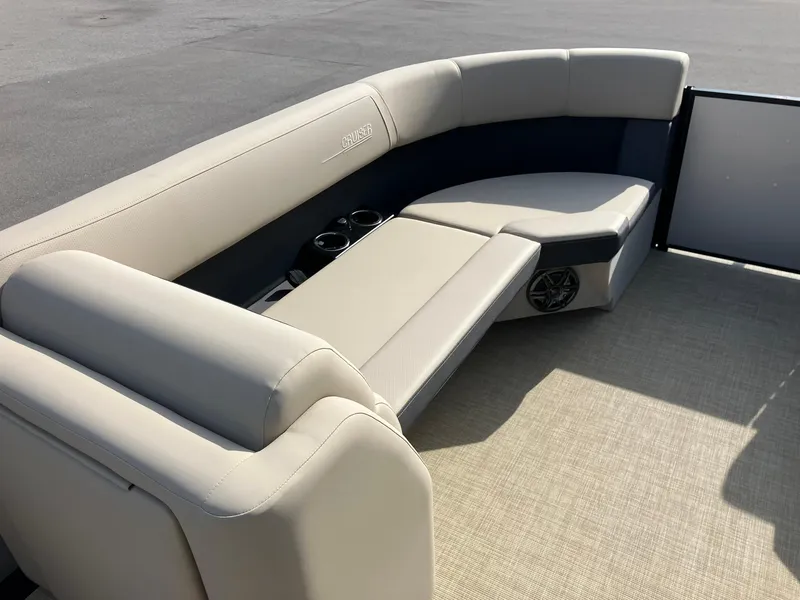 Slide: The Image of 2025 Harris Cruiser 230 boat interior with beige seating and cup holders. - 16