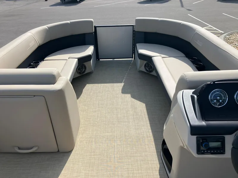Slide: The Image of 2025 Harris Cruiser 230 boat interior with beige seating and modern dashboard. - 18