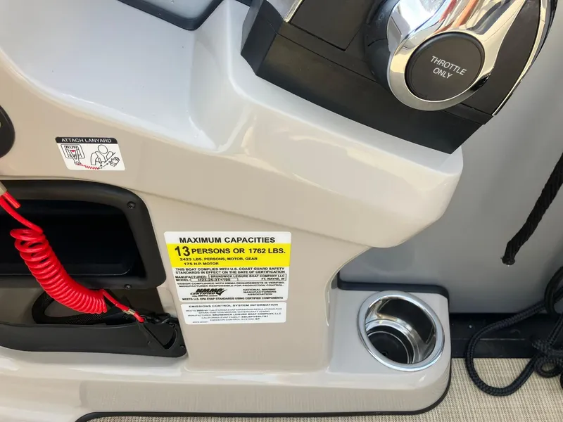 Slide: The Image of Control panel of 2025 Harris Cruiser 230 boat, showing throttle and capacity label. - 19