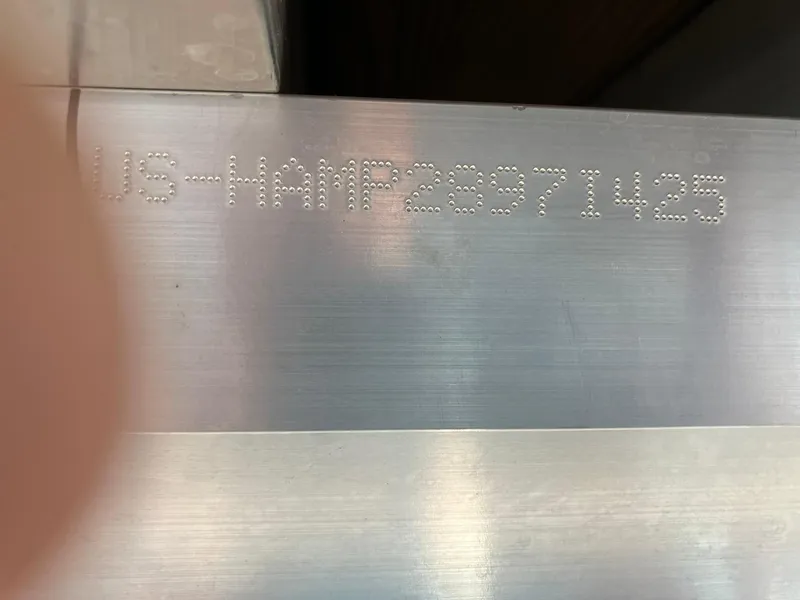 Slide: The Image of 2025 Harris Cruiser 230 hull identification number engraved on metal surface. - 20