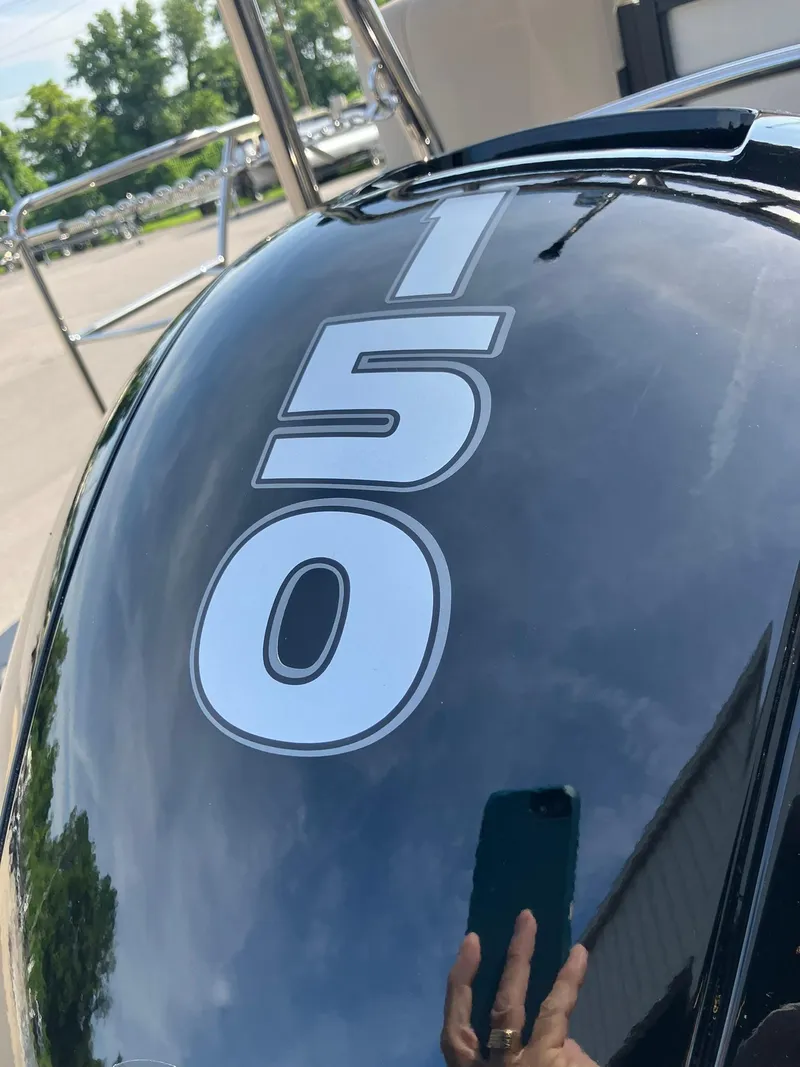 Slide: The Image of Close-up of 2025 Harris Cruiser 230 engine cover with '150' marking. - 21