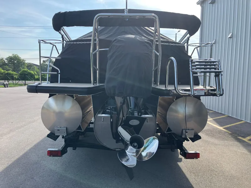 Slide: The Image of 2025 Harris Cruiser 230 pontoon boat rear view with covered deck and dual propellers. - 6
