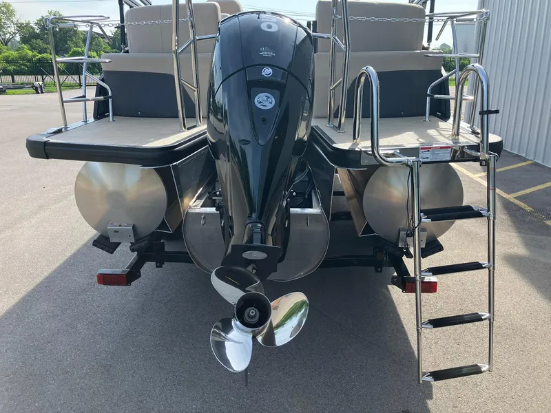 Slide: The Image of 2025 Harris Cruiser 230 pontoon boat rear view with motor and ladder. - 7