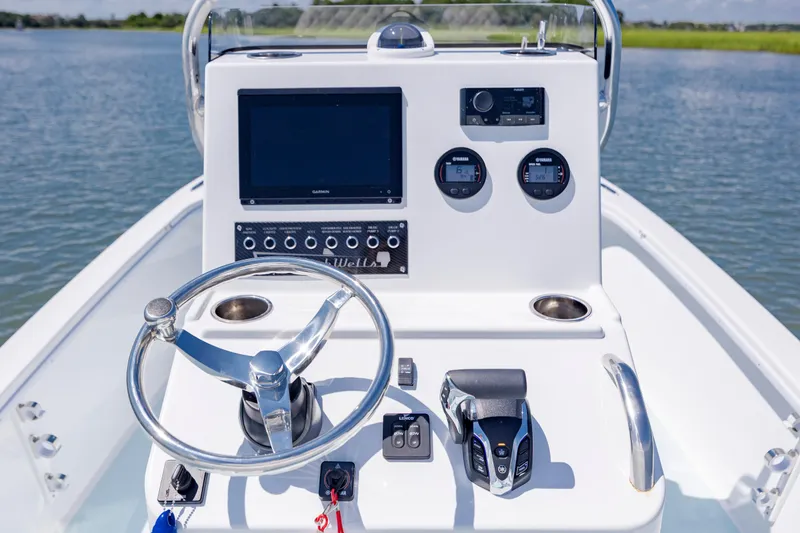 Slide: The Image of Cockpit of 2025 Spanish Wells 21 boat with modern controls and steering wheel. - 13