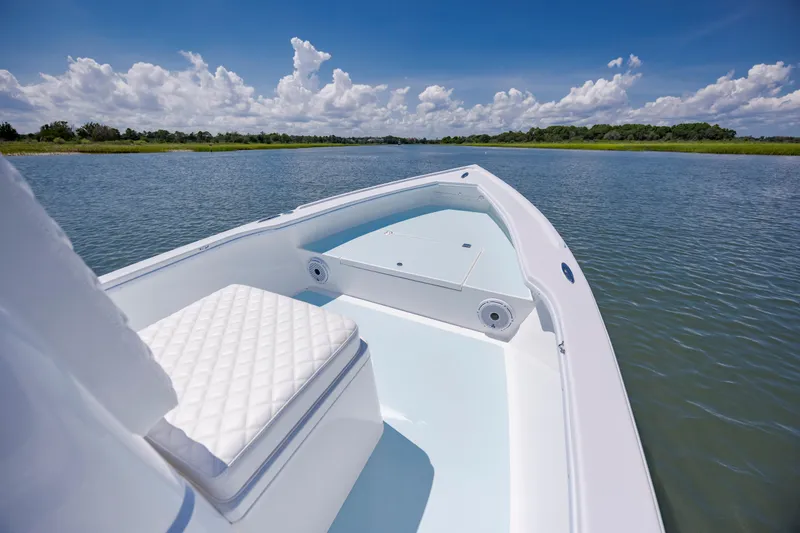 Slide: The Image of 2025 Spanish Wells 21 boat on calm water under a clear blue sky. - 14