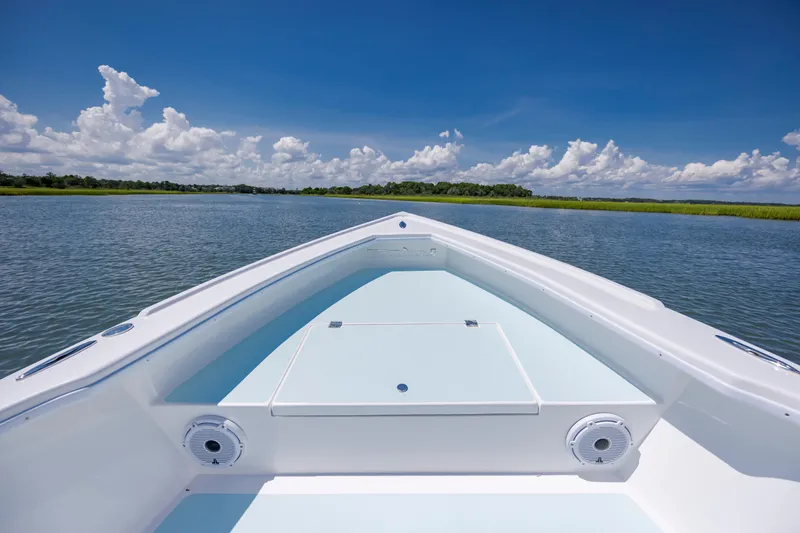 Slide: The Image of Bow view of 2025 Spanish Wells 21 boat on calm water under blue sky. - 15