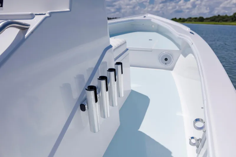 Slide: The Image of 2025 Spanish Wells 21 boat interior with rod holders, sleek design, and calm water backdrop. - 16