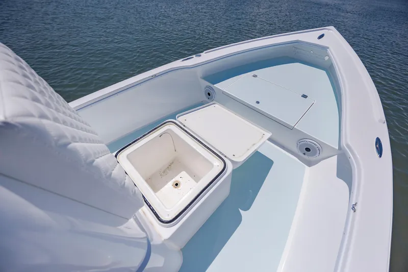 Slide: The Image of 2025 Spanish Wells 21 boat interior with storage compartments on calm water. - 18