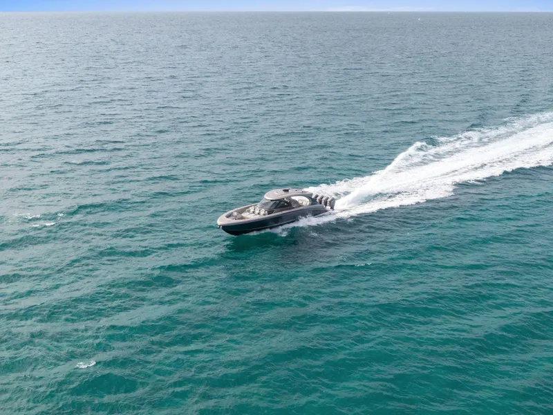 Slide: The Image of 2024 Mystic Powerboats M5200 cruising on open ocean waters. - 11