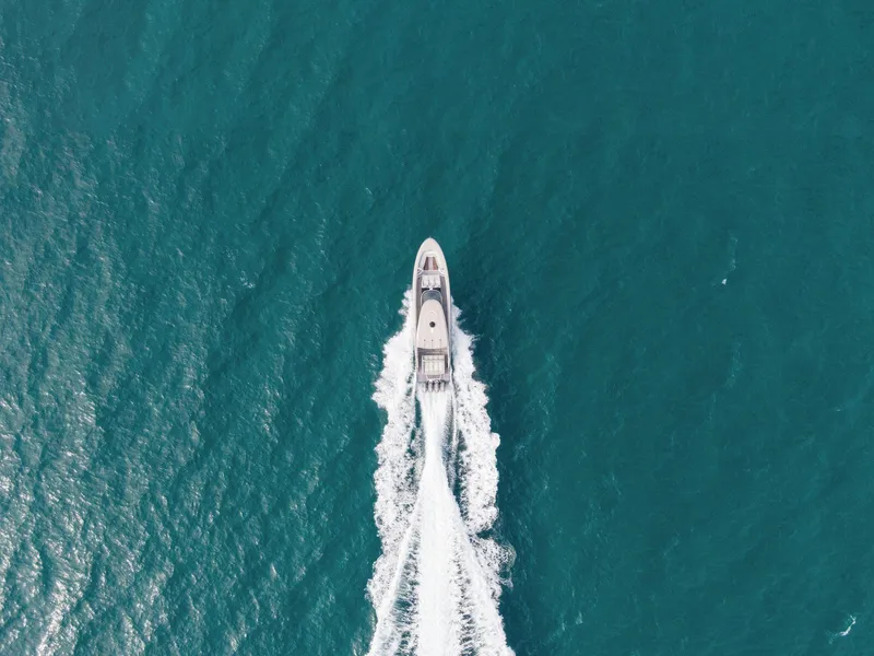 Slide: The Image of Aerial view of 2024 Mystic Powerboats M5200 cruising on open water. - 18