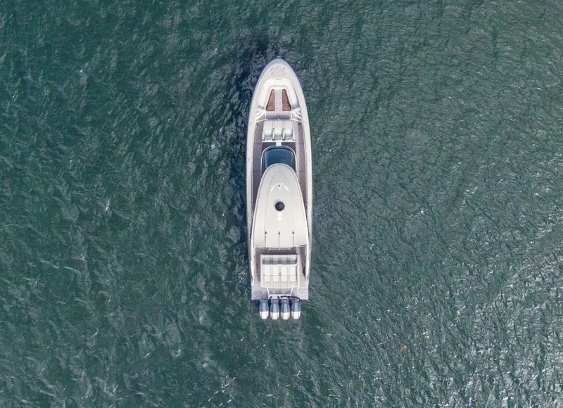Slide: The Image of Aerial view of 2024 Mystic Powerboats M5200 on open water. - 21