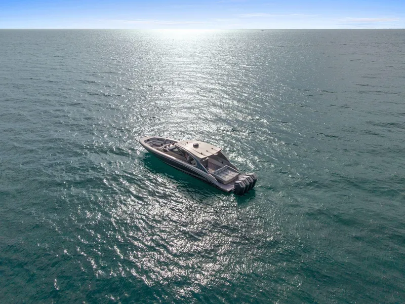 Slide: The Image of 2024 Mystic Powerboats M5200 cruising on open water under clear skies. - 35