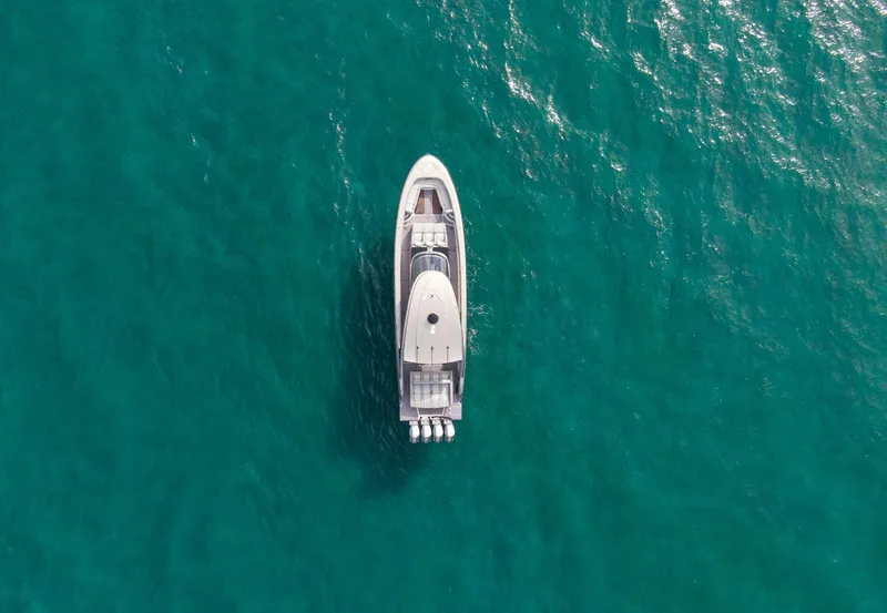 Slide: The Image of Aerial view of 2024 Mystic Powerboats M5200 on turquoise water. - 4